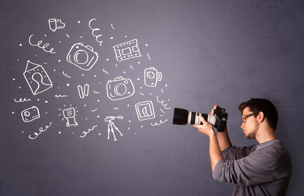 man filming icons on a table 