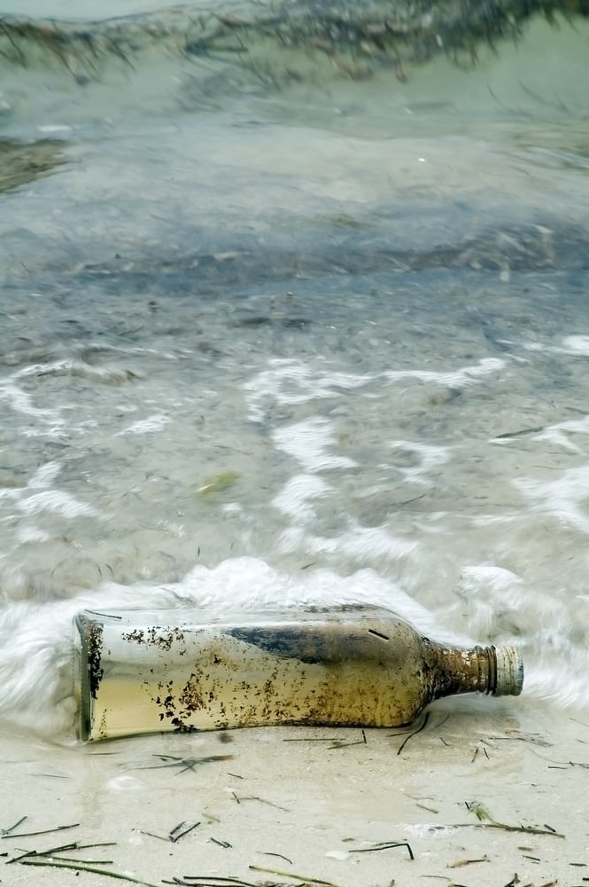 Bottle with a message on seashore