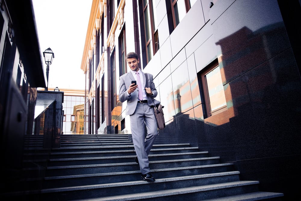 Young business man walking down the stairs. 