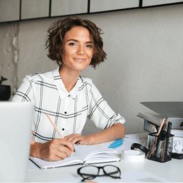 Woman working at desk smiling
